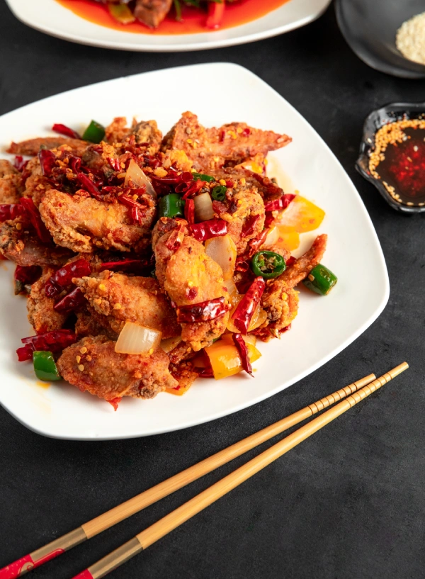 fried-chicken-with-red-green-chili-peppers-onion-plate